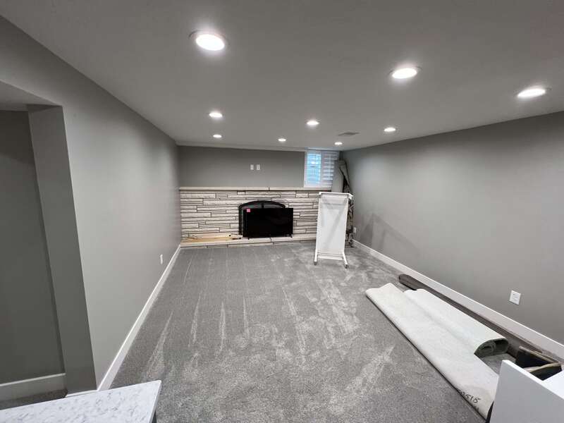 basement living room with fireplace